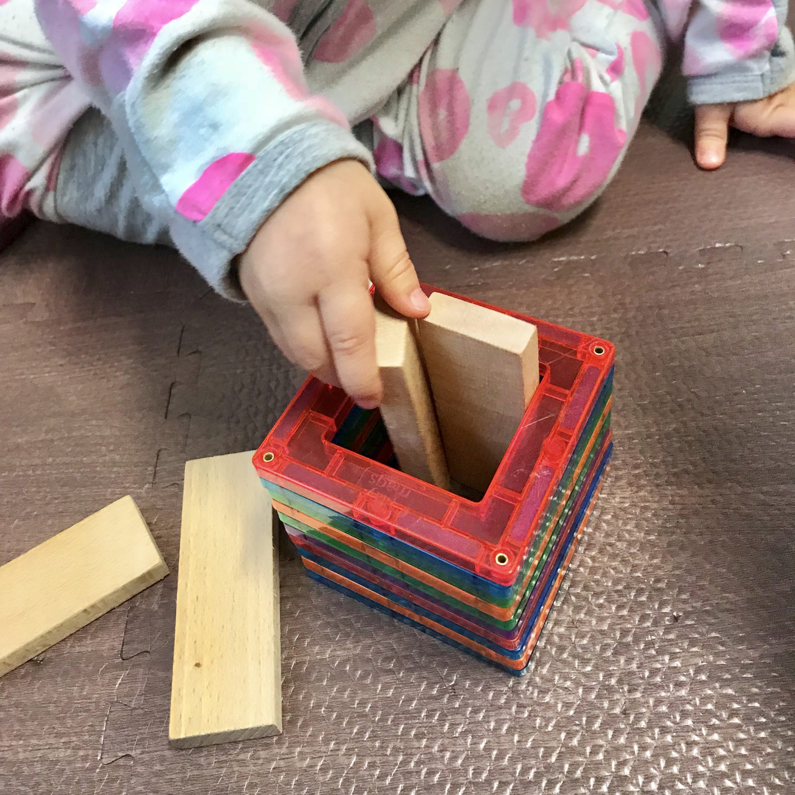 1 year old playing with magnetic tiles