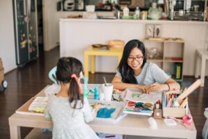 Play coach and her daughter doing process art at home