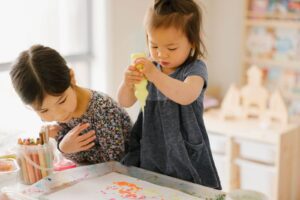 A toddler squeezing paint for process art