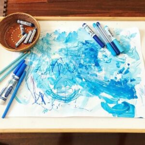 Materials needed for invitation to create by adding a second layer of art medium (blue Sharpie markers) over existing artwork (blue tone artwork)