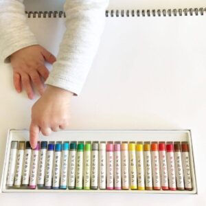 A set of oil pastels from Daiso, featuring a variety of vibrant colors neatly arranged in a box. The pastels are ready for use, offering a smooth, rich medium for drawing and coloring, perfect for creative projects.